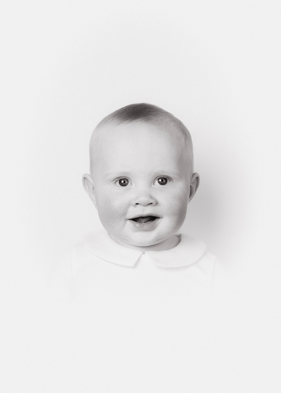 Heirloom portrait — a young child in a white collar, classical black and white